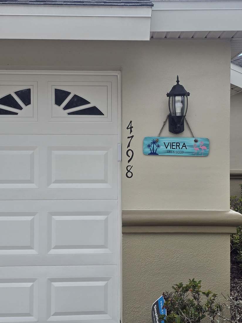 Repainted home exterior with dark garage door