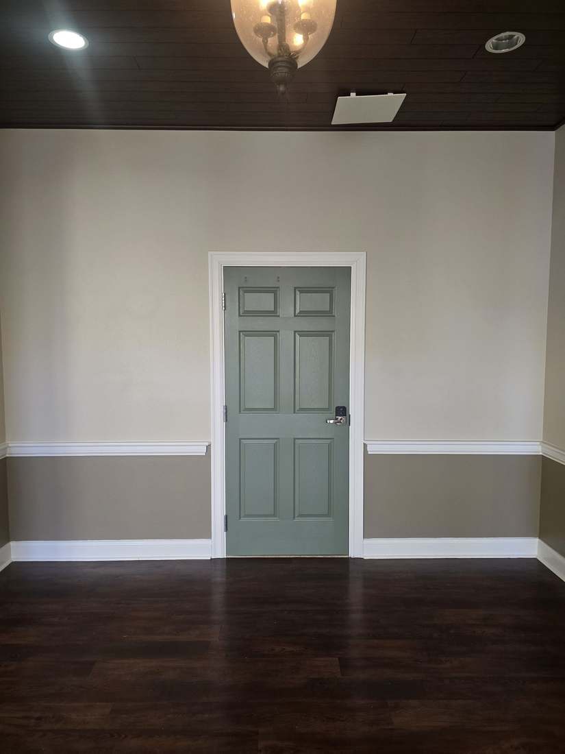 Freshly painted interior hallway with green door